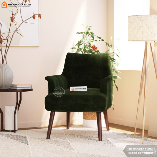 Green armchair in a living room setting with decor elements.